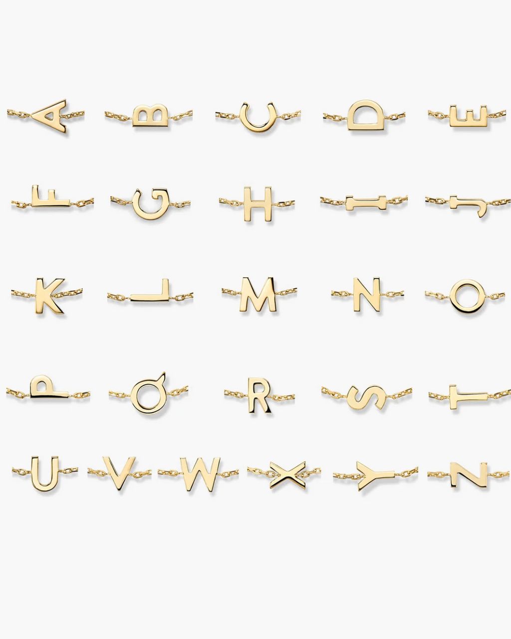Collection of gold initial necklaces on a white background