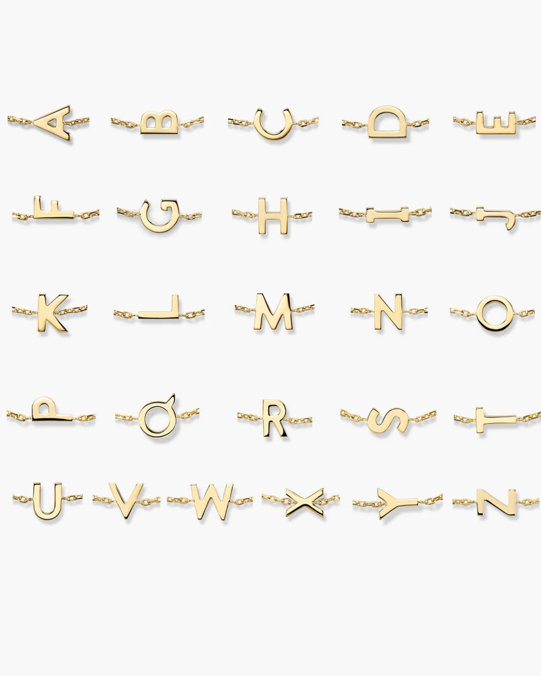 Collection of gold initial necklaces on a white background