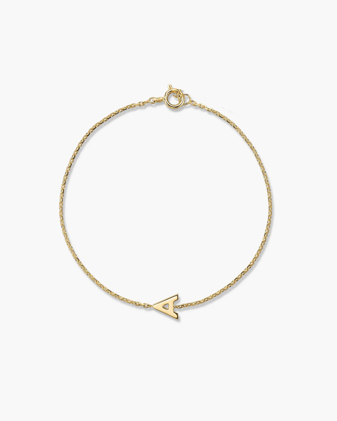 Gold bracelet with a small arrow charm on a white background