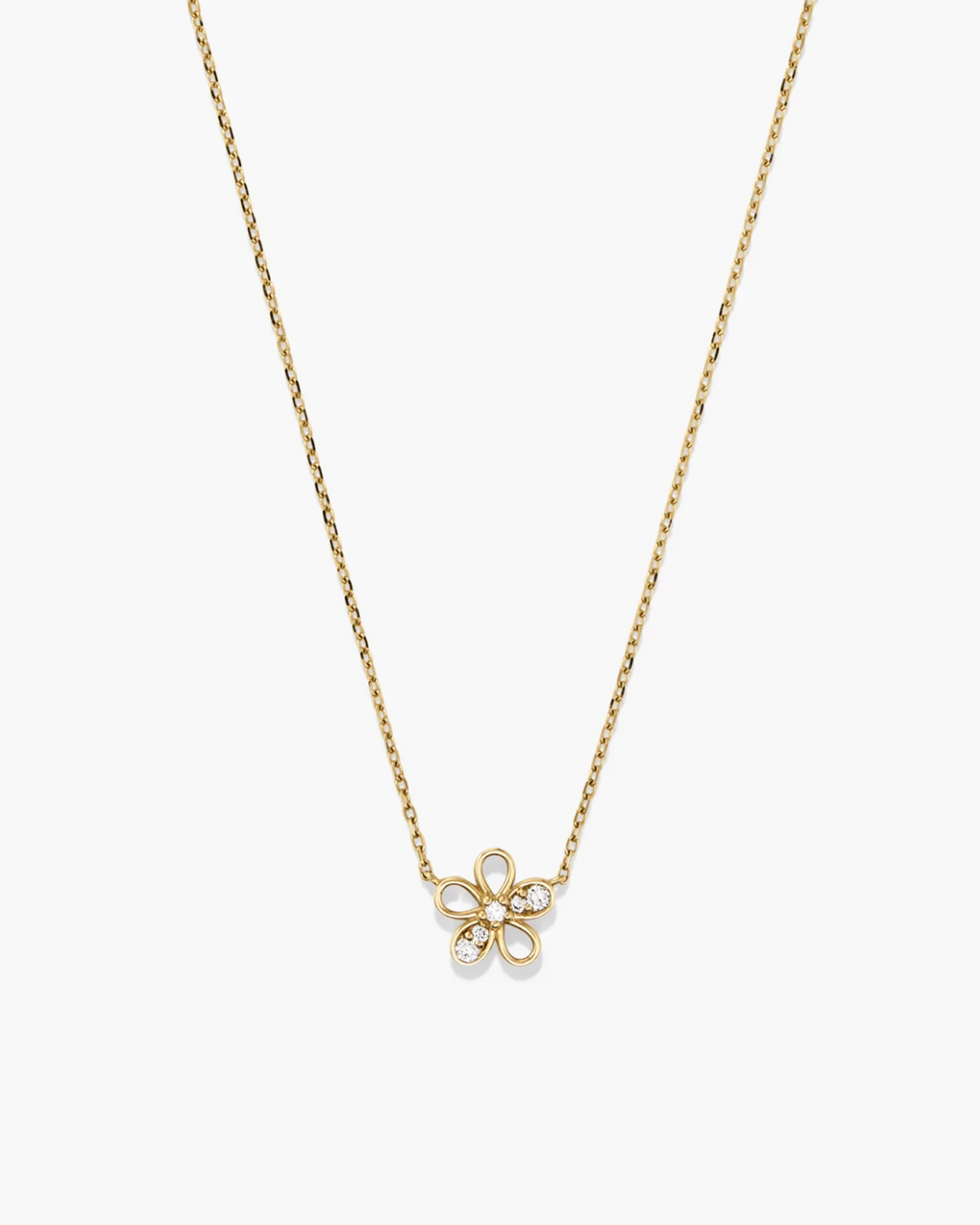 Gold necklace with a delicate flower pendant on a white background