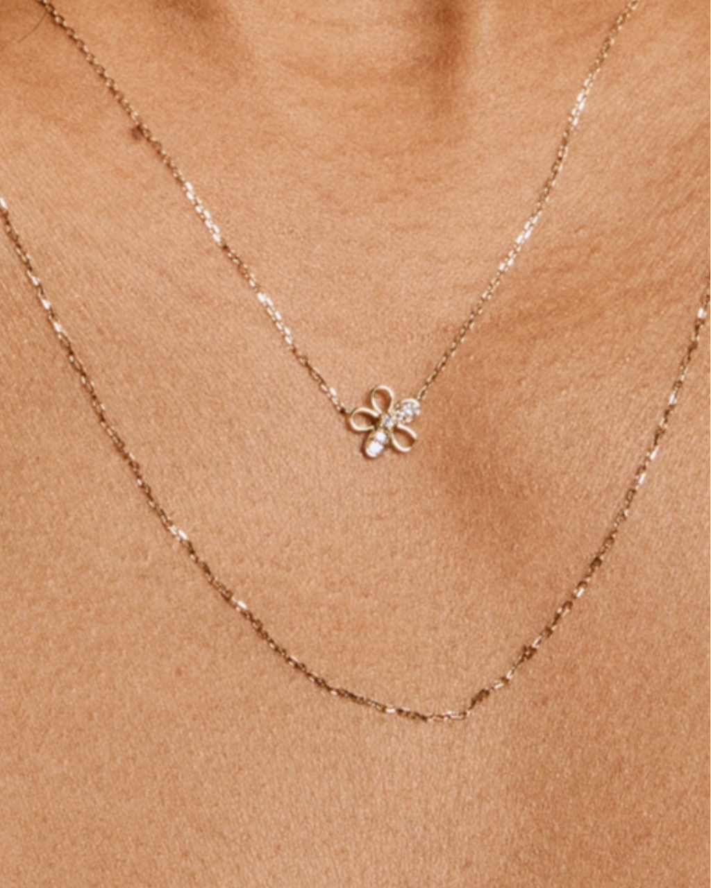 Necklace with a flower-shaped pendant on a beige background