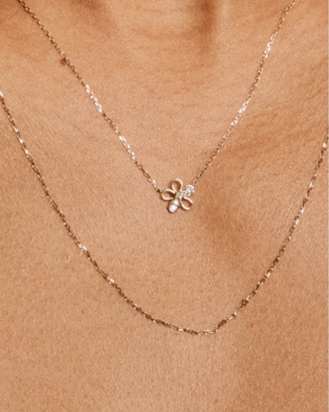 Necklace with a flower-shaped pendant on a beige background