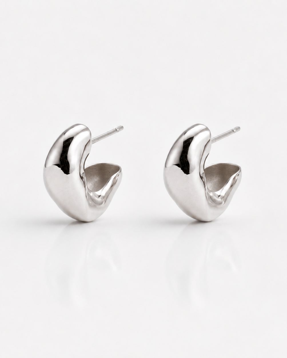 Pair of silver earrings on a white background