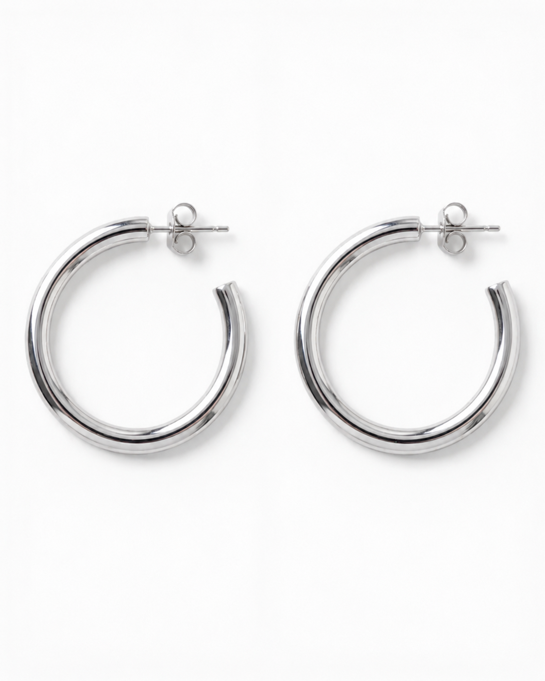 Pair of silver hoop earrings on a white background