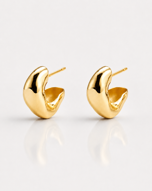 Gold hoop earrings on a light gray background