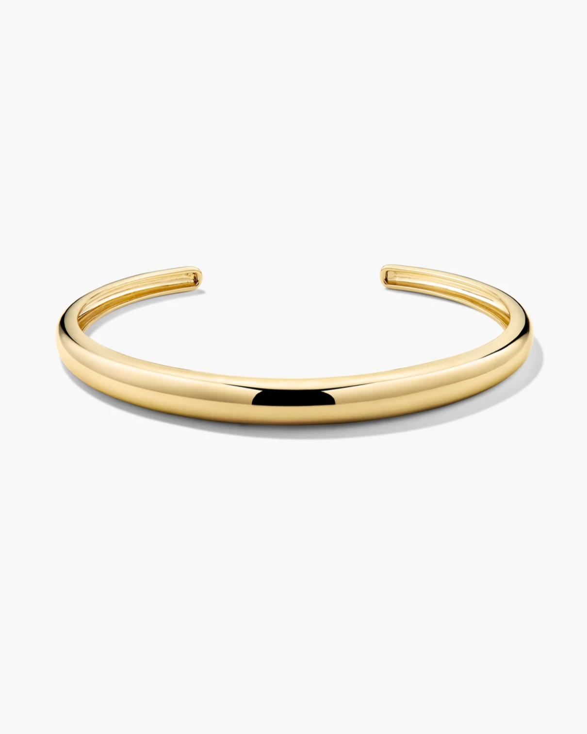 Gold bangle on a white background