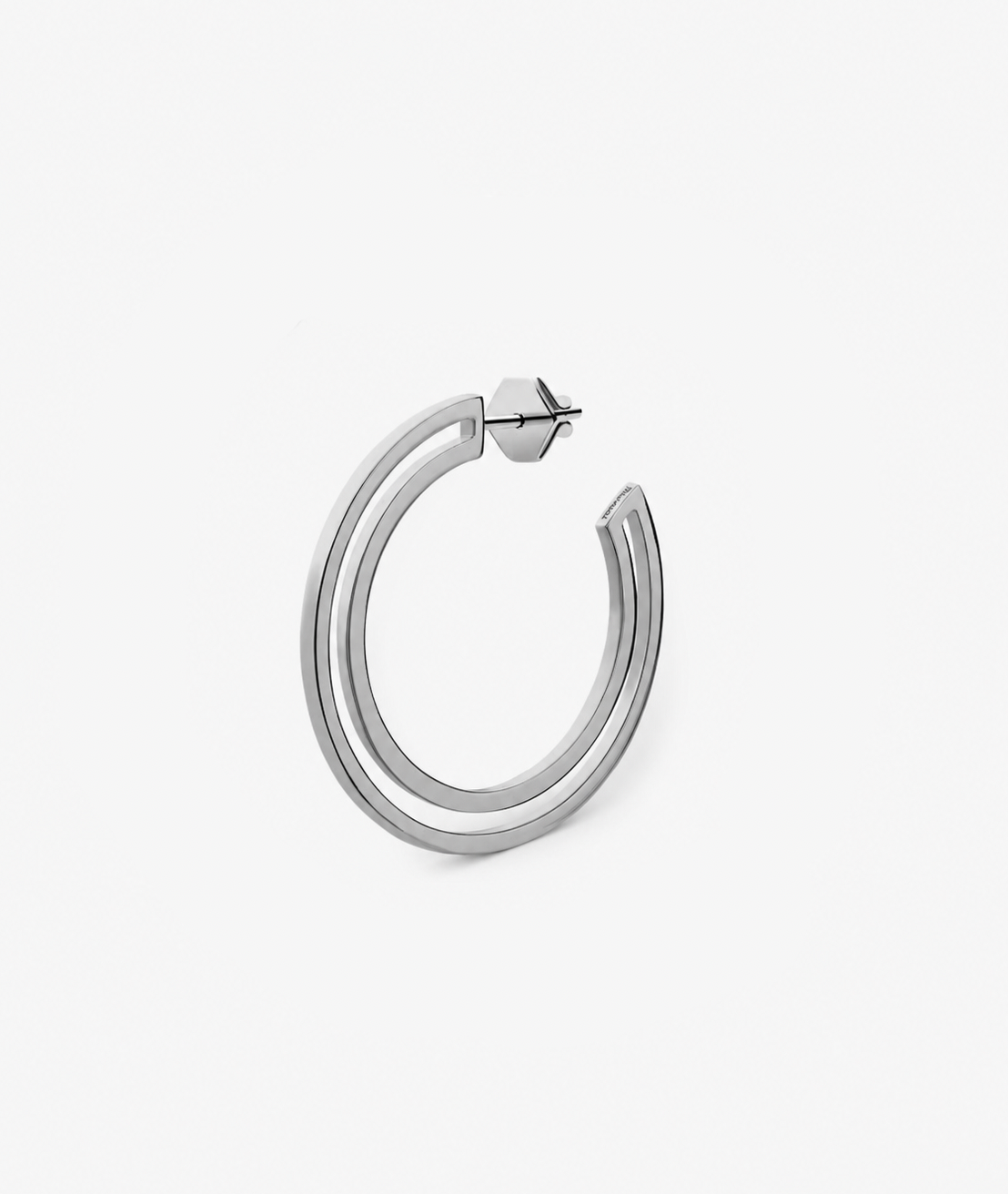 Silver hoop earring on a light gray background