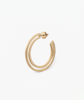 Gold hoop earring on a white background