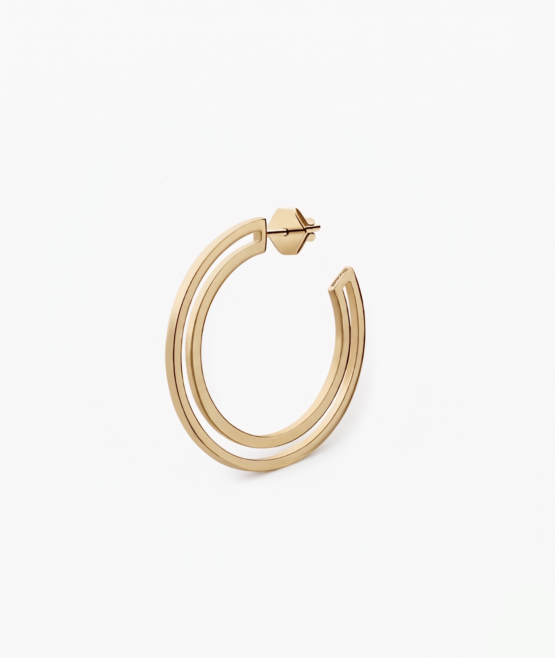 Gold hoop earring on a white background