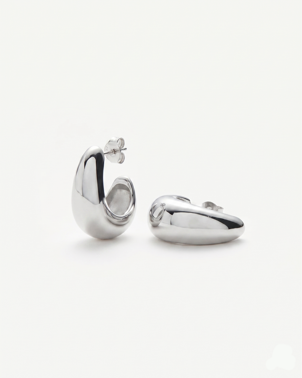 Pair of silver hoop earrings on a white background