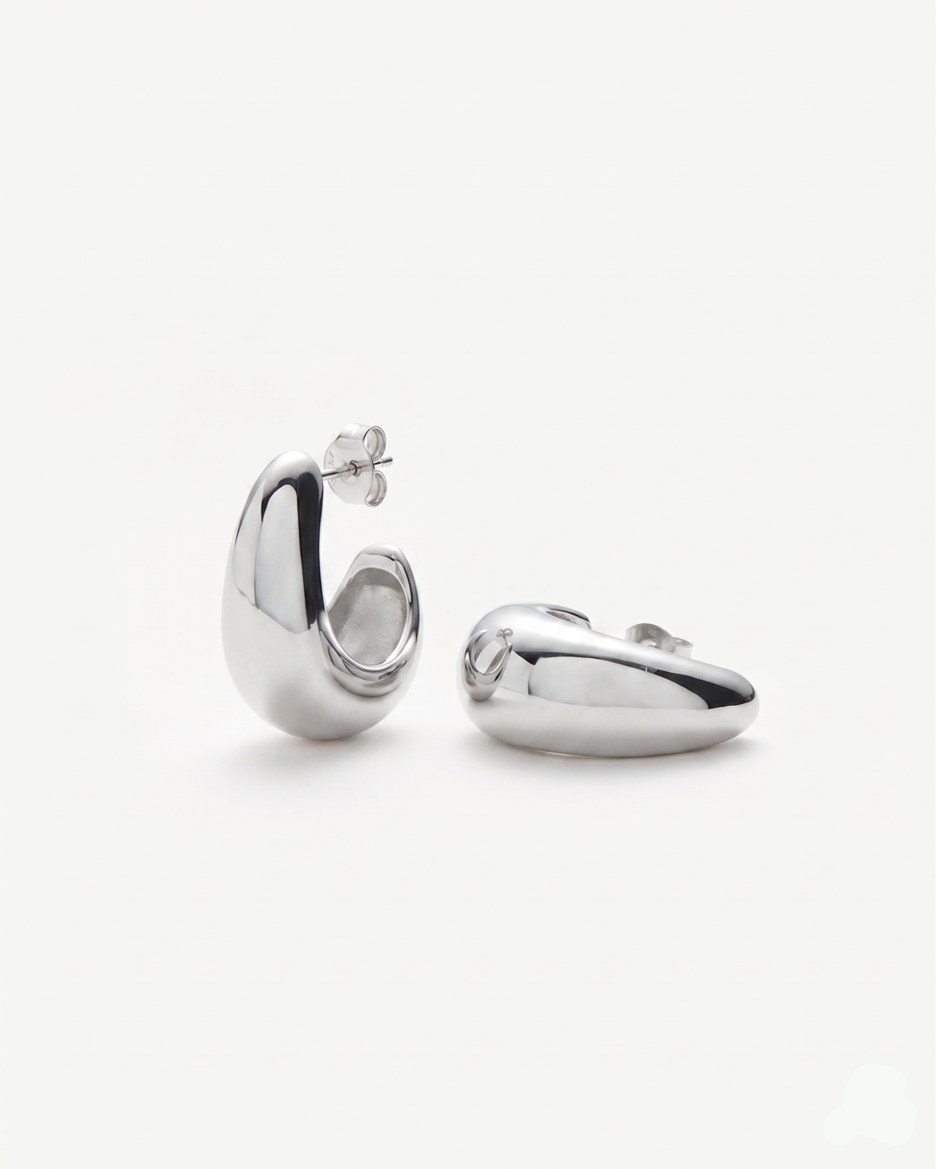 Pair of silver hoop earrings on a white background