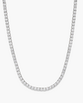 Silver chain necklace on a light gray background