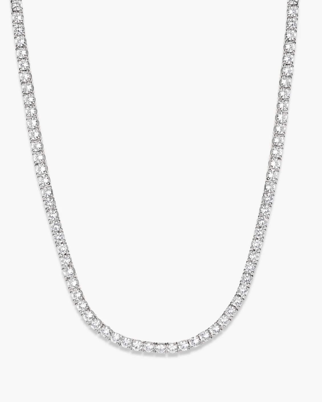 Silver chain necklace on a light gray background