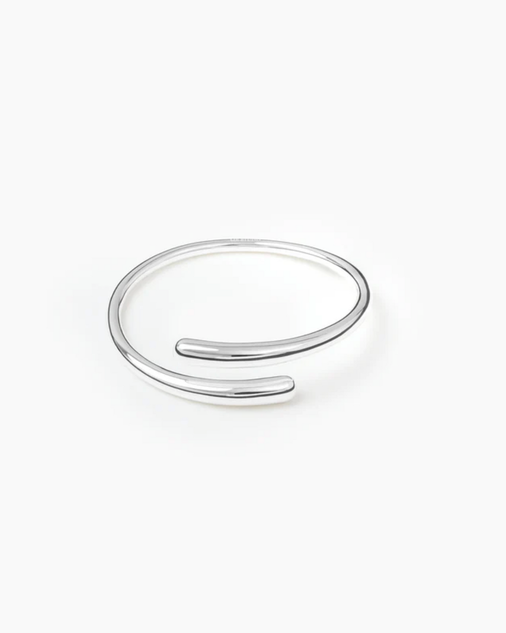 Silver open bangle on a white background